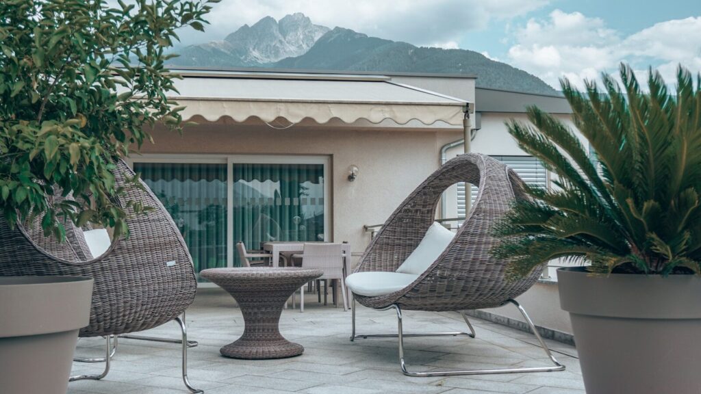 a patio with chairs and a table